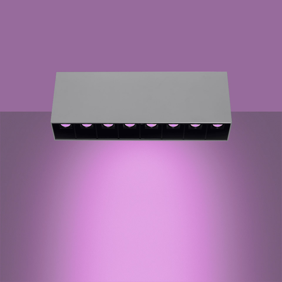 Artemide Sharp SMD ceiling light: rectangular white fixture with 8 black recessed LED cells emitting purple light downward