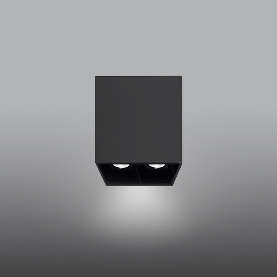 Artemide Sharp SMD ceiling spotlight: matte black square housing with two recessed LED modules emitting focused downward light