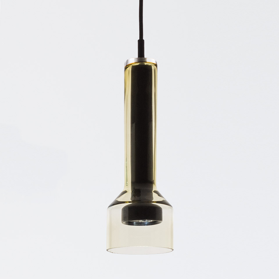 Artemide Stablight pendant lamp: tall cylindrical amber glass tube atop a wide cylindrical diffuser, suspended by black cord