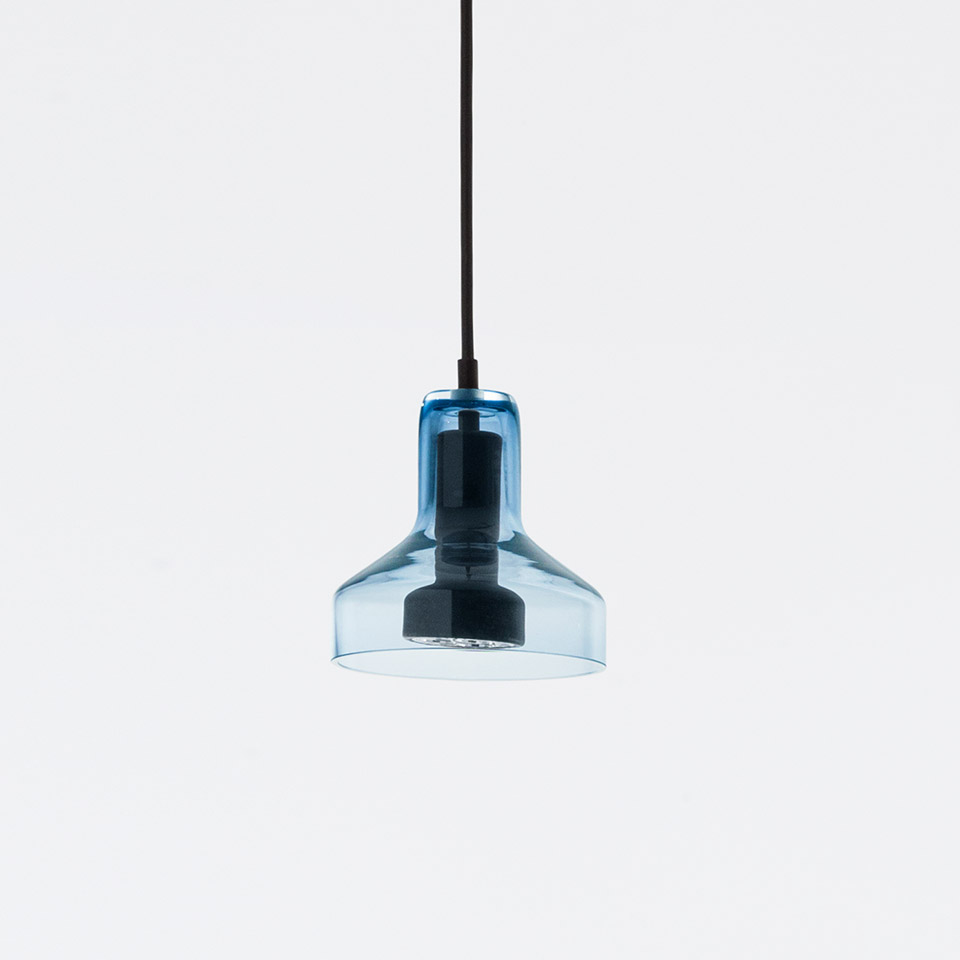 Artemide Stablight pendant lamp with transparent blue glass shade and black metal fitting, suspended from a black cord