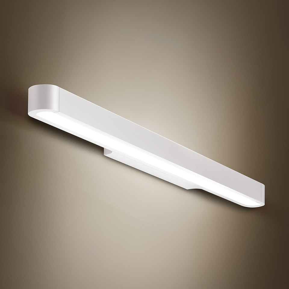 Artemide Talo wall lamp: elongated white LED bar mounted horizontally, emitting warm diffused light from its lower edge