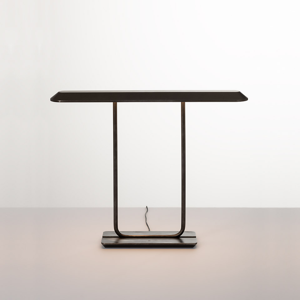 Artemide Tempio table lamp in dark bronze finish, featuring a flat rectangular shade on a U-shaped metal frame with rectangular base