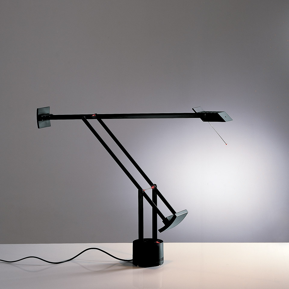 Artemide Tizio desk lamp in black, featuring a counterbalanced arm, adjustable halogen head, and minimalist base on a white surface