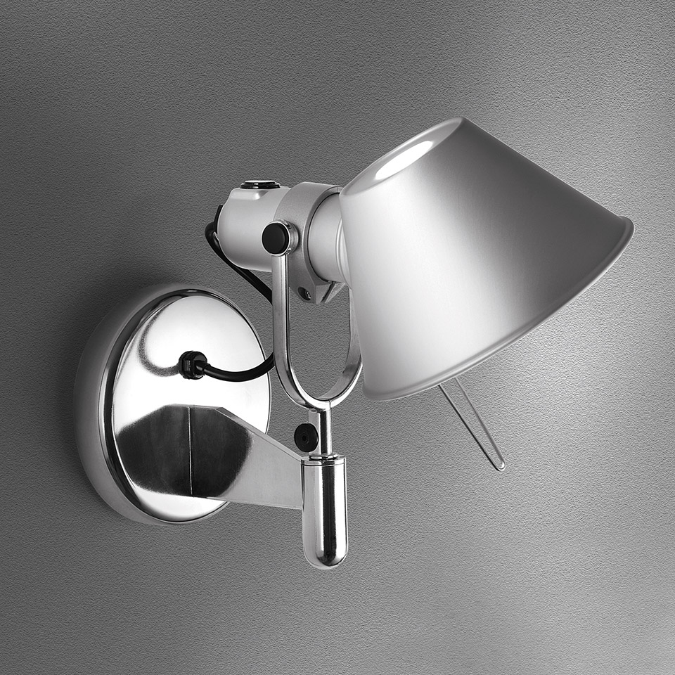 Artemide Tolomeo Faretto wall spotlight in polished aluminum with adjustable arm and conical shade, mounted on circular wall bracket