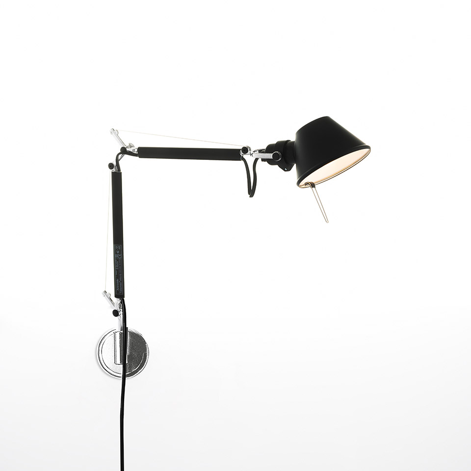 Artemide Tolomeo Micro Parete wall lamp in black, featuring adjustable articulated arm and small conical shade, mounted on chrome wall bracket