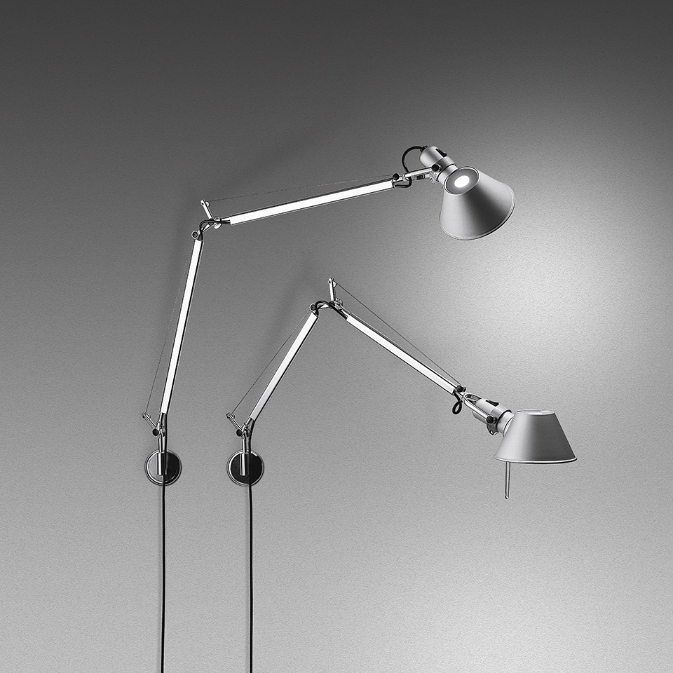 Two Artemide Tolomeo Parete wall lamps in aluminium with adjustable articulated arms and conical shades, one illuminated