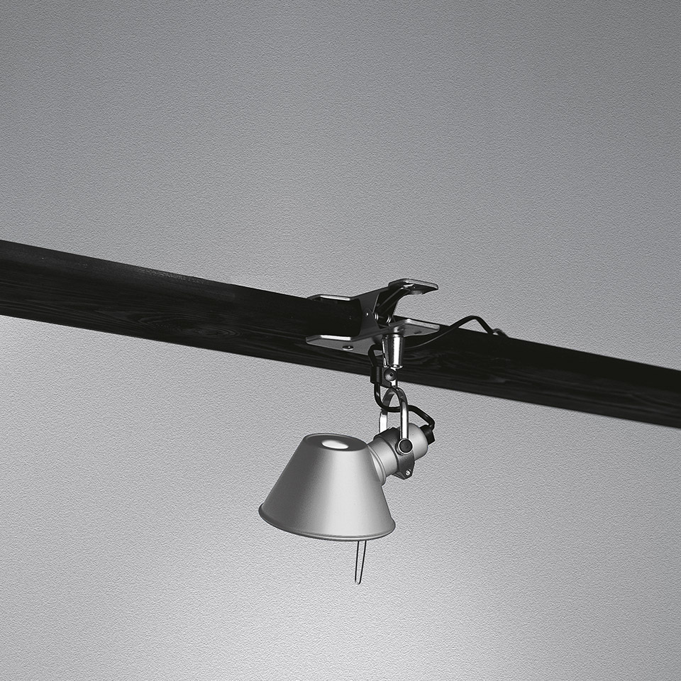 Artemide Tolomeo Pinza clip lamp in aluminum, clamped onto a dark beam, with adjustable conical shade hanging downward