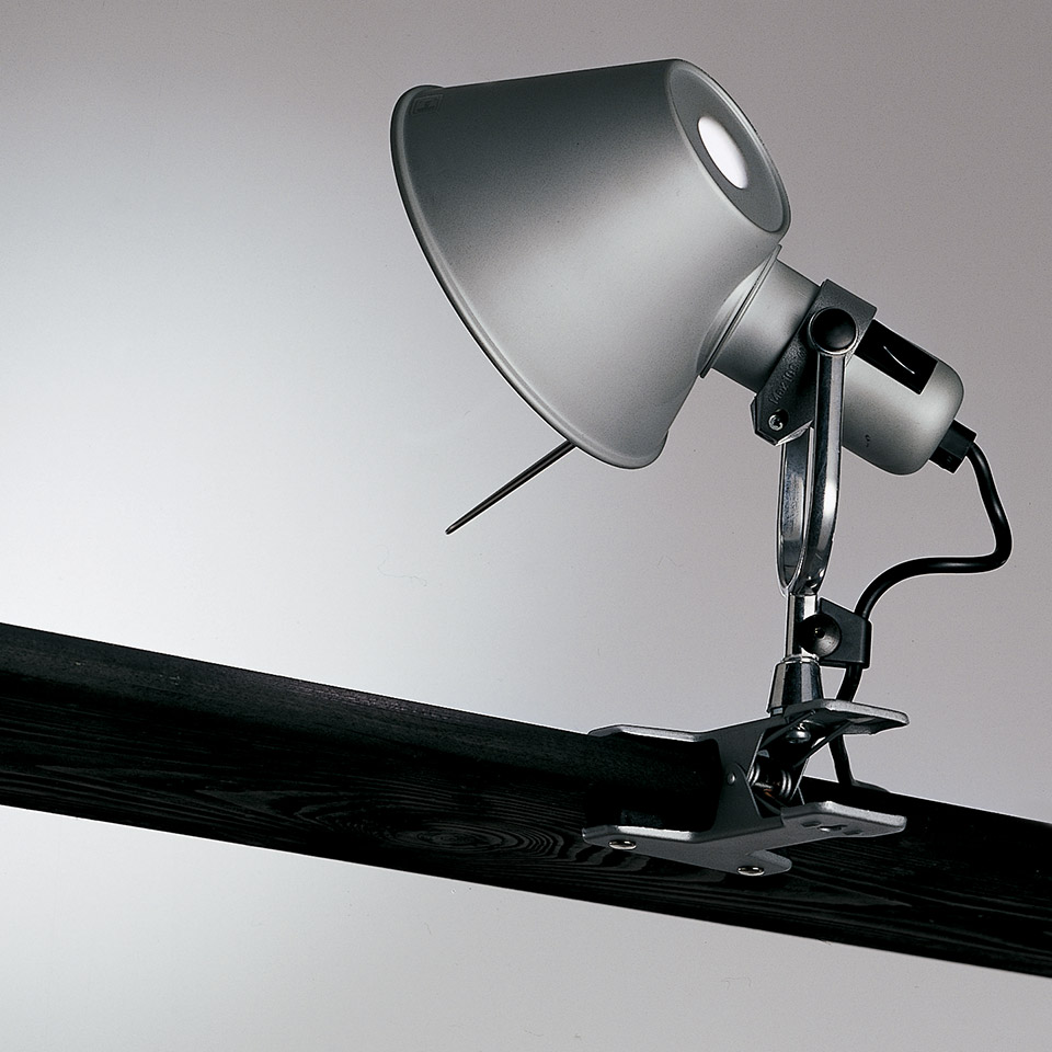 Artemide Tolomeo Pinza clip lamp in aluminum, with conical shade and adjustable arm, clamped onto a dark wooden beam