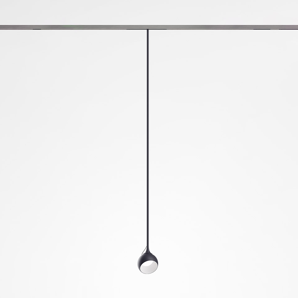 Artemide Turn Around System: dark pendant spotlight with teardrop-shaped head hanging from a ceiling track via a thin black cable
