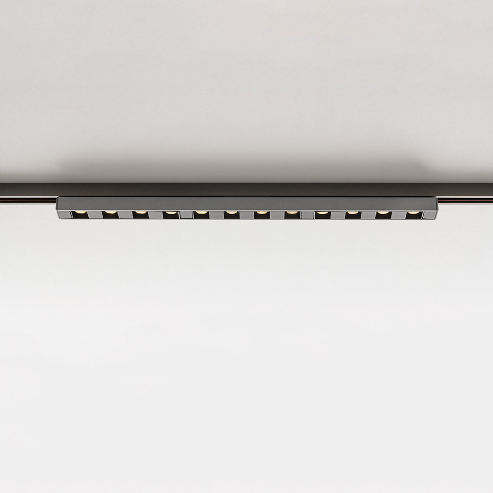 Artemide Turn Around System: sleek black linear LED track light with 12 adjustable spotlights mounted on ceiling rail