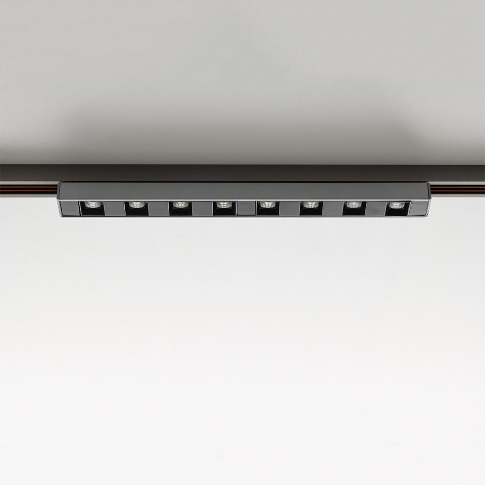 Artemide Turn Around System: black linear track-mounted LED spotlight bar with 9 square adjustable spotlights on ceiling rail