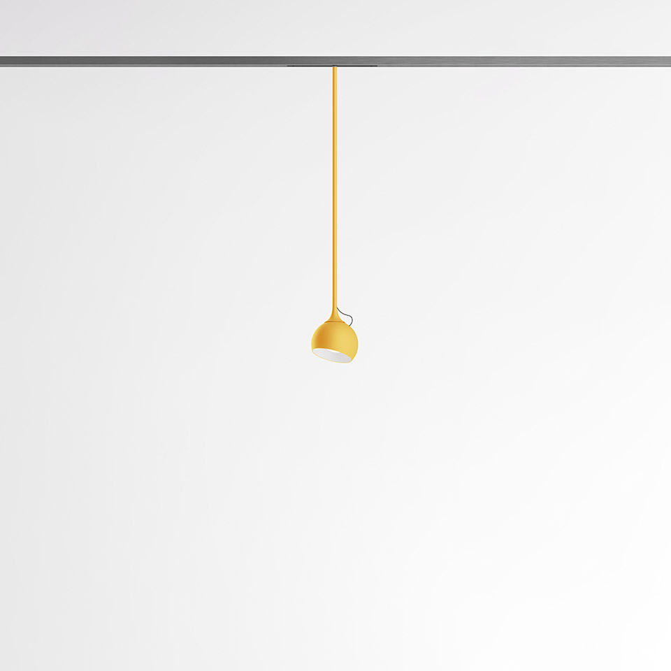 Artemide Turn Around System: yellow pendant lamp with dome shade hanging from a ceiling track rail via a matching yellow cord