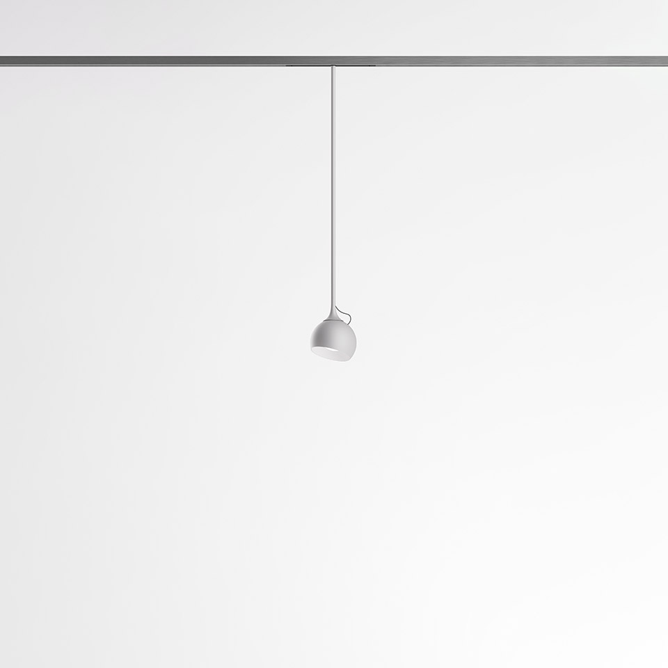 Artemide Turn Around System: small white dome pendant lamp suspended from a ceiling track rail via a thin white cable