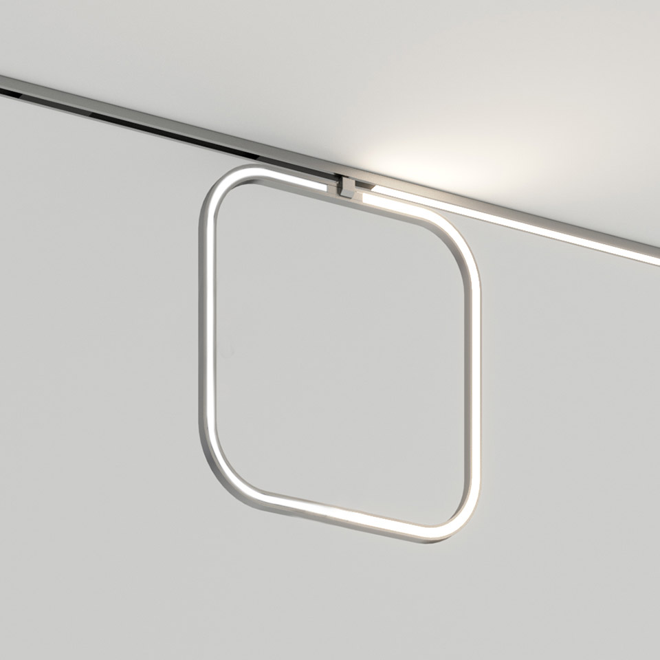 Artemide Turn Around System: square LED ring pendant with rounded corners mounted on a ceiling track rail, emitting soft white light