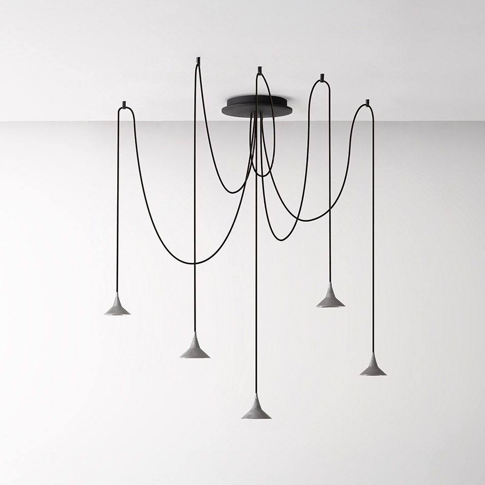 Artemide Unterlinden multi-pendant chandelier: five conical concrete shades on long draped black cords from a single ceiling canopy