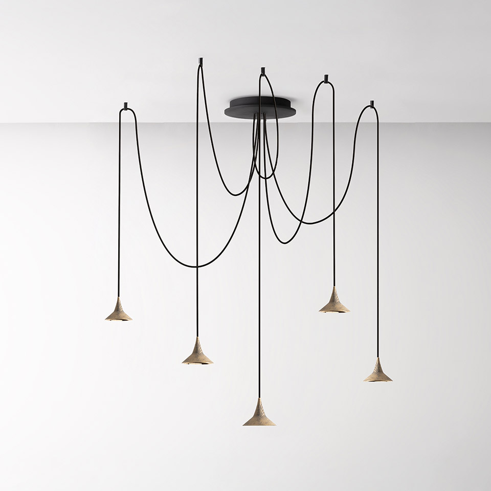 Artemide Unterlinden chandelier: five conical natural-finish pendants on draped black cords from a single black ceiling rose