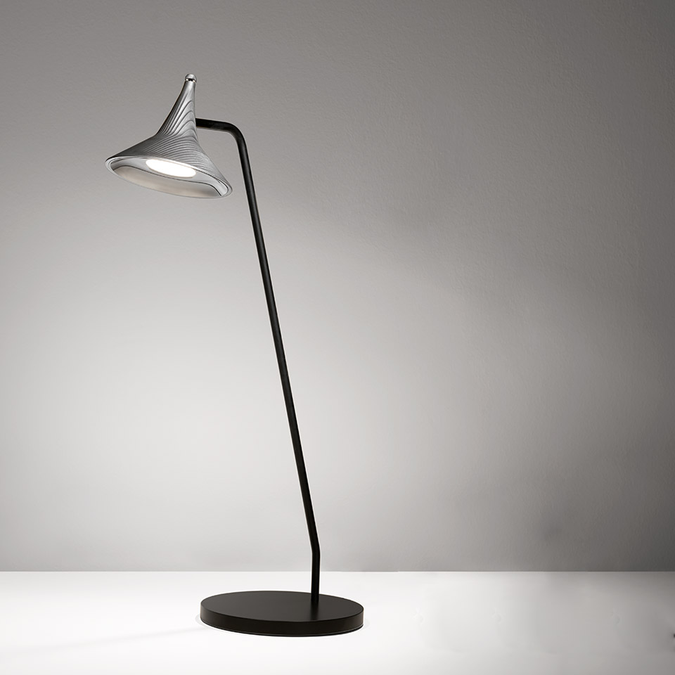 Artemide Unterlinden table lamp: curved black stem with round base, adjustable silver fluted conical LED shade