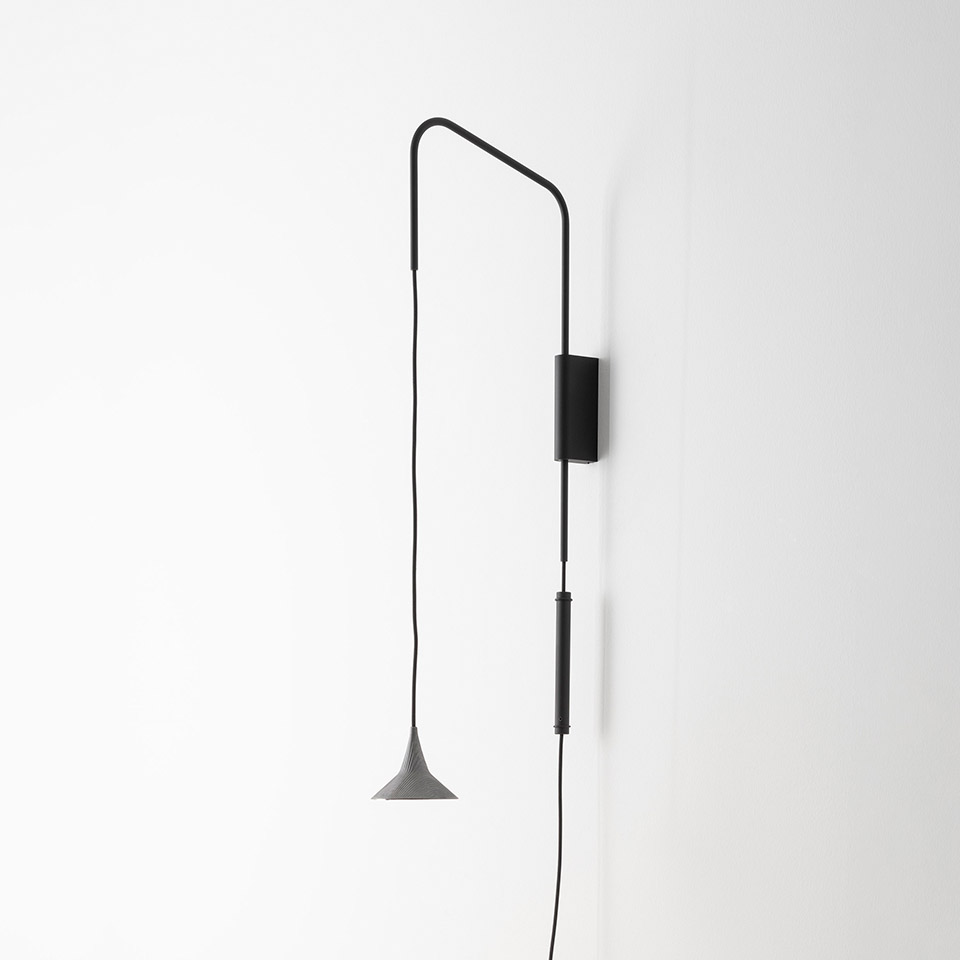 Artemide Unterlinden wall lamp: black swing arm bracket with adjustable cord and small conical grey shade pendant