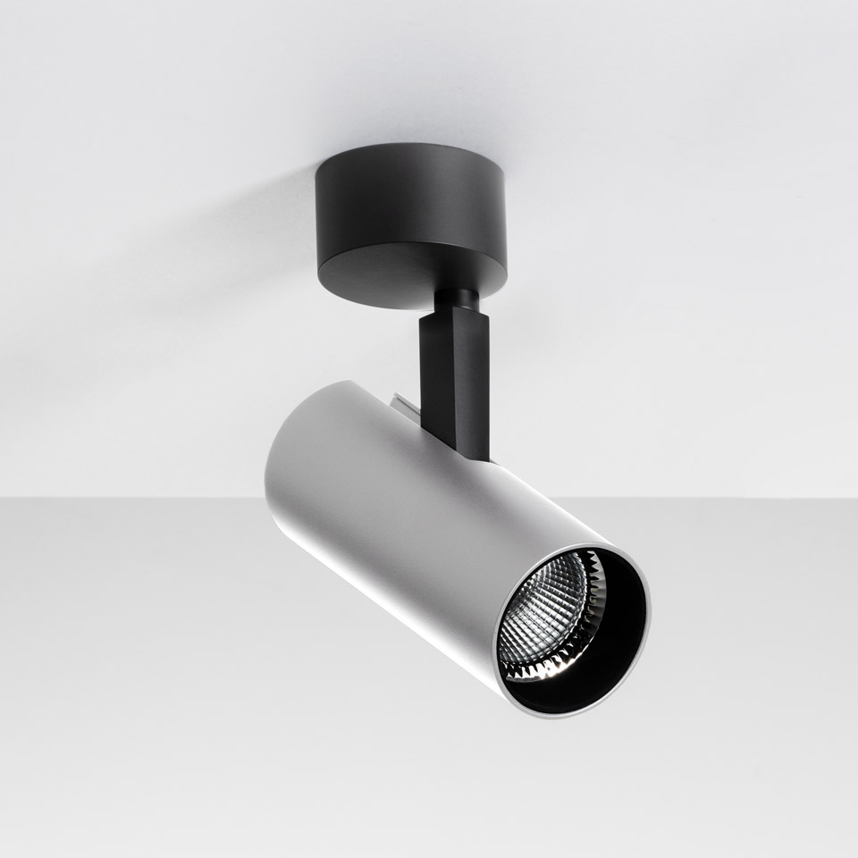 Artemide Vector Ceiling spotlight: white cylindrical LED head on black arm and ceiling mount, tilted downward for directional lighting
