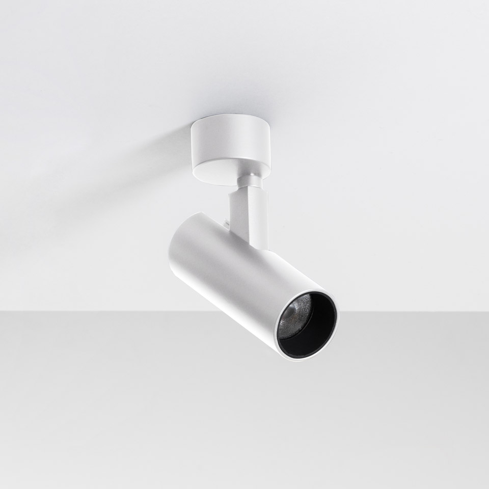 Artemide Vector Ceiling spotlight in white, adjustable cylindrical LED fixture with black interior, mounted on ceiling