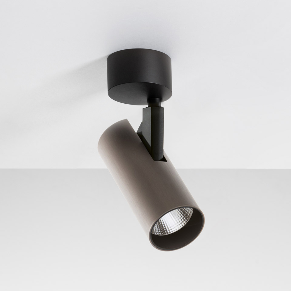 Artemide Vector Ceiling spotlight: adjustable cylindrical LED head in dark grey, mounted on black ceiling base with articulated arm