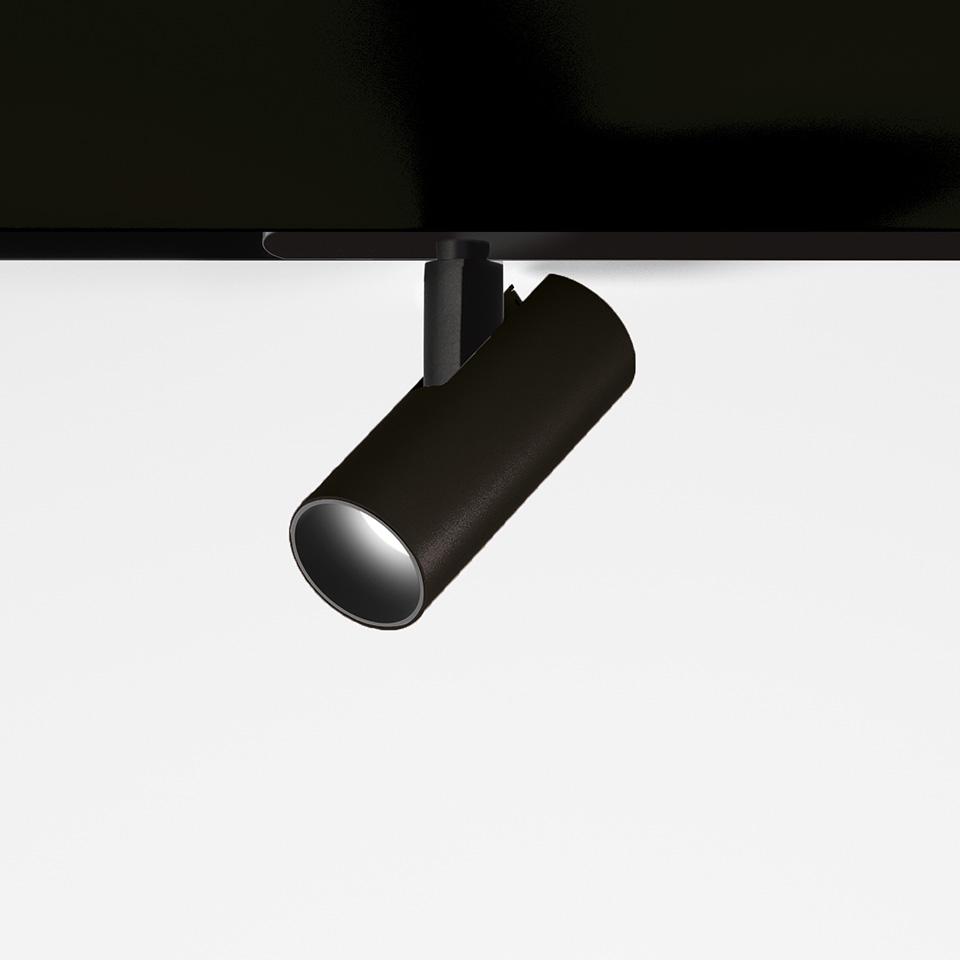 Artemide Vector Magnetic track spotlight in matte black, cylindrical body tilted on magnetic rail mount, directional LED.