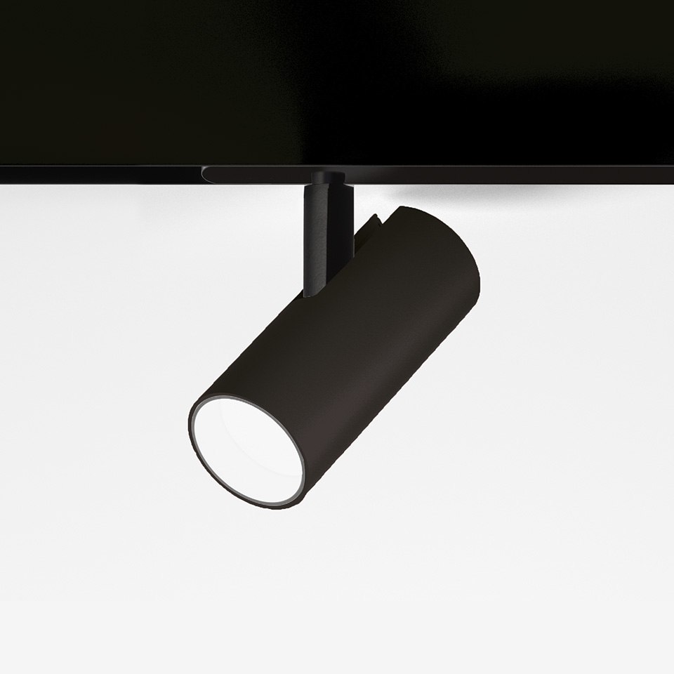 Artemide Vector Magnetic track spotlight in matte black, cylindrical body, adjustable head mounted on a magnetic track system