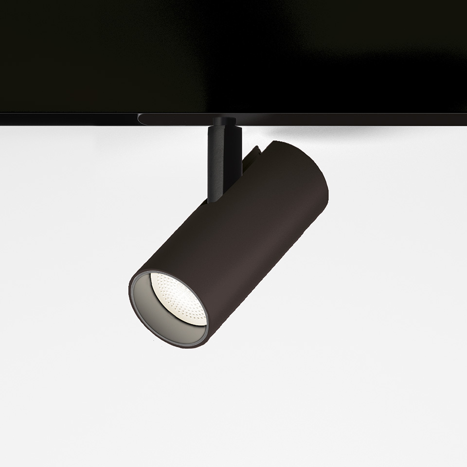 Artemide Vector Magnetic track spotlight in black, cylindrical body with LED lens, mounted on black magnetic track rail.