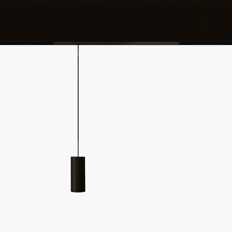 Artemide Vector Pendant Magnetic: black cylindrical pendant lamp suspended by a thin cable from a black magnetic track rail