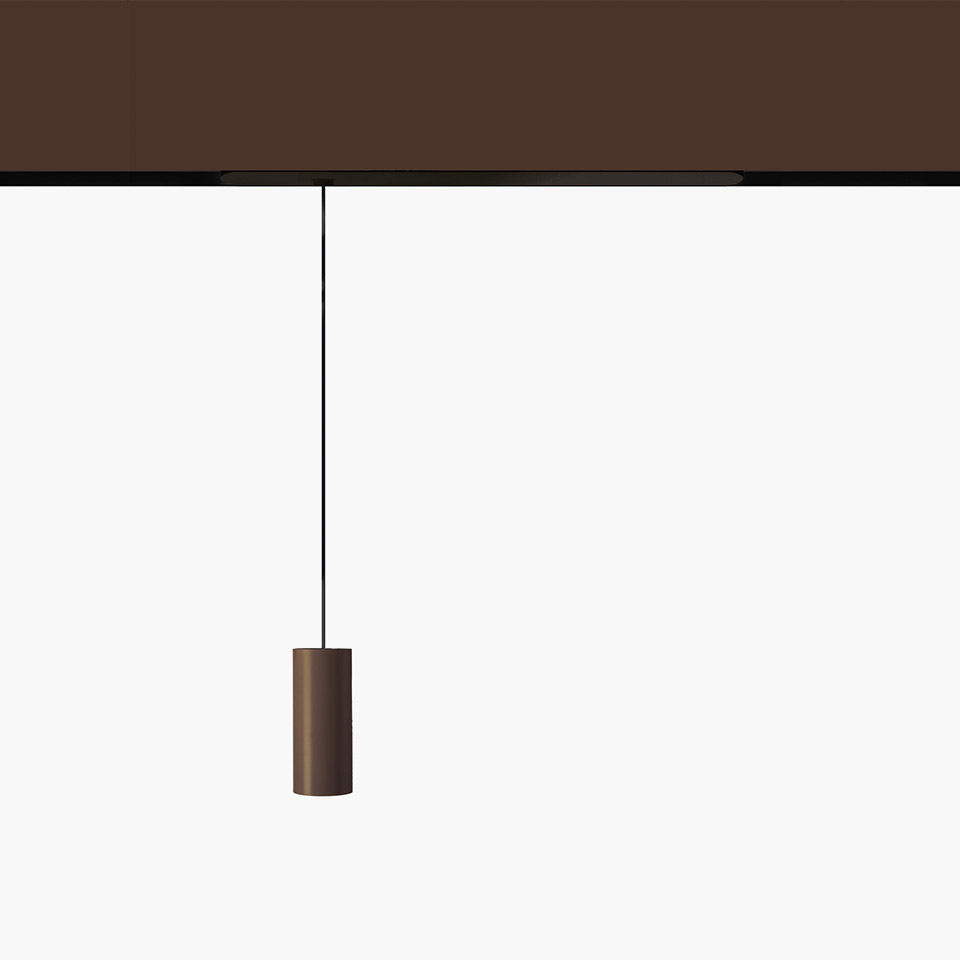 Artemide Vector Pendant Magnetic: cylindrical bronze pendant lamp suspended by a thin black cord from a dark magnetic track