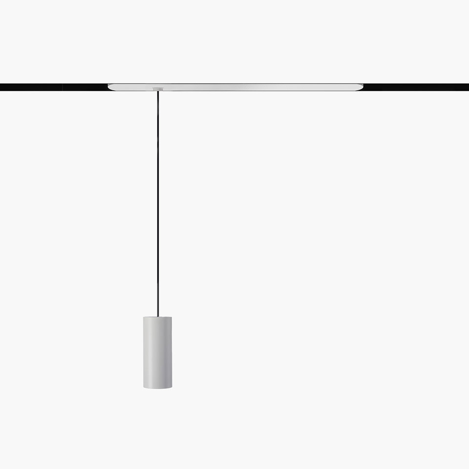 Artemide Vector Pendant Magnetic: white cylindrical pendant lamp suspended by black cable from a magnetic track rail