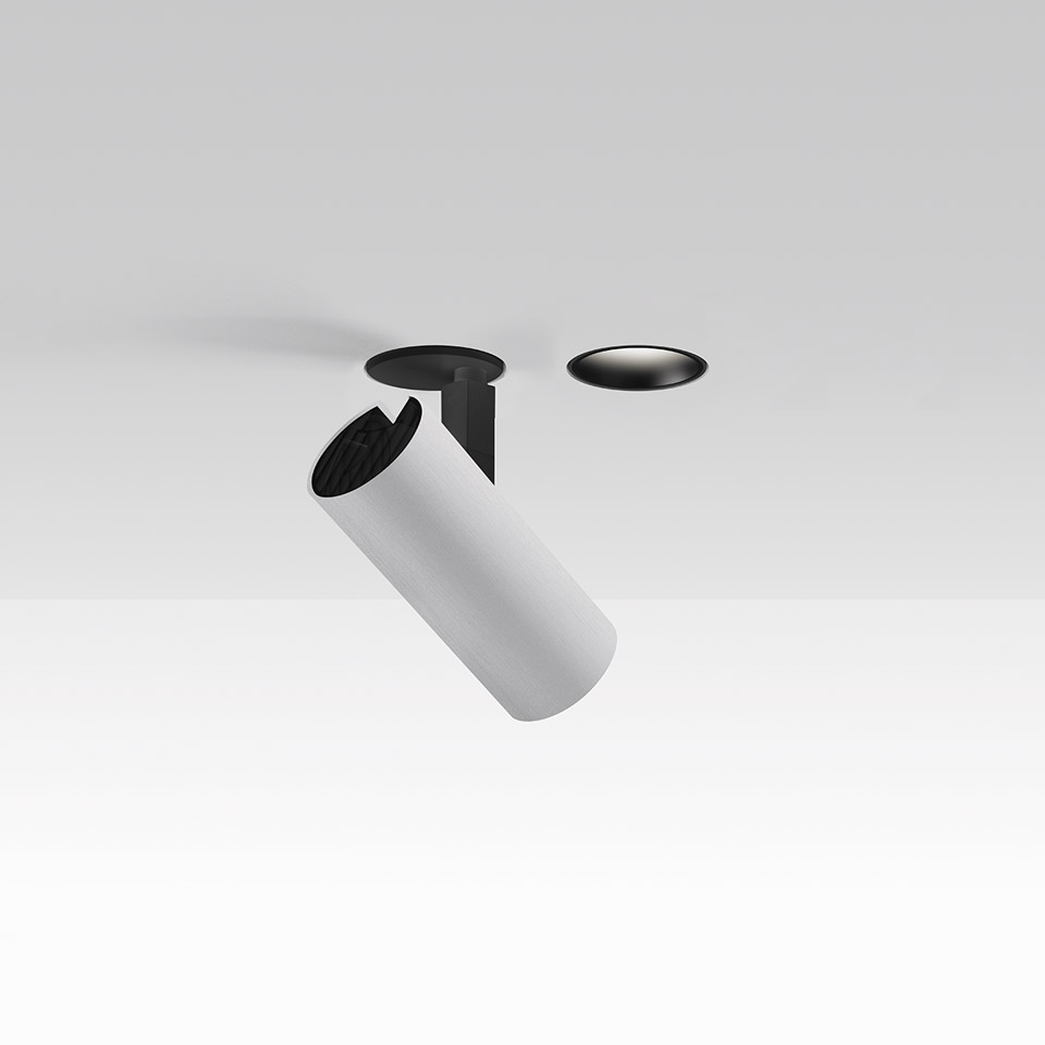 Artemide Vector Recessed spotlight: white cylindrical body tilted downward with black trim, shown with separate flush ceiling plate