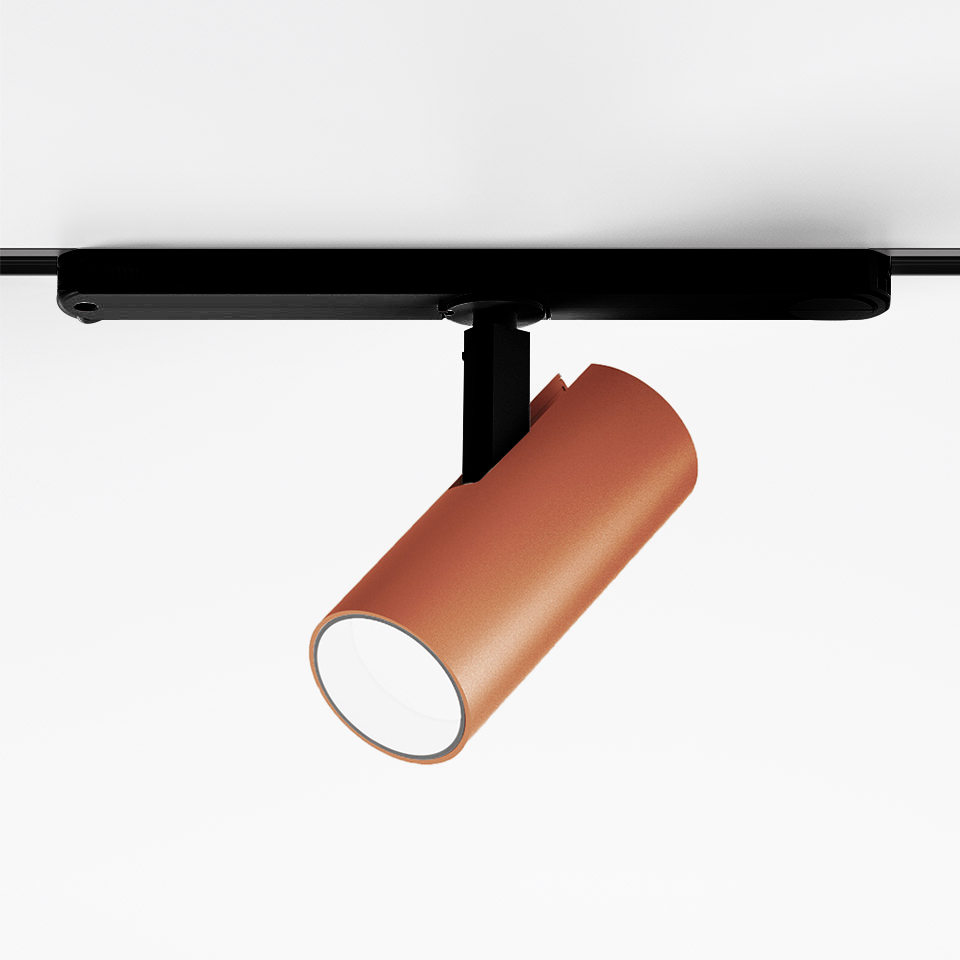 Artemide Vector Track 230V spotlight: terracotta cylindrical head on black track mount, adjustable directional LED fixture