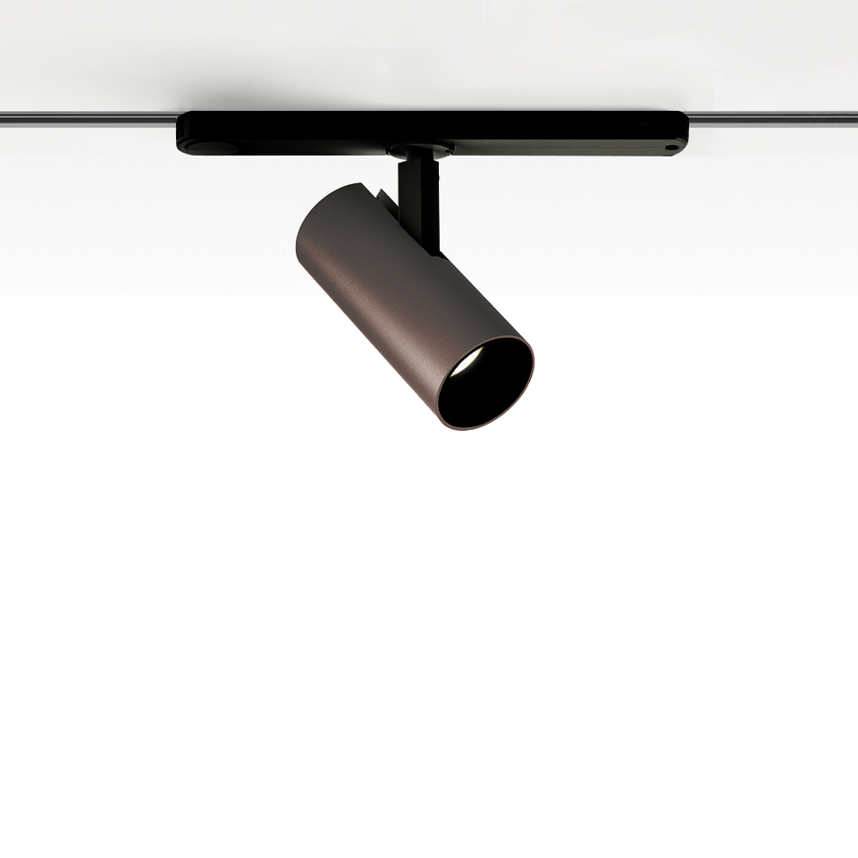 Artemide Vector Track 230V: bronze cylindrical adjustable spotlight mounted on a black track rail system