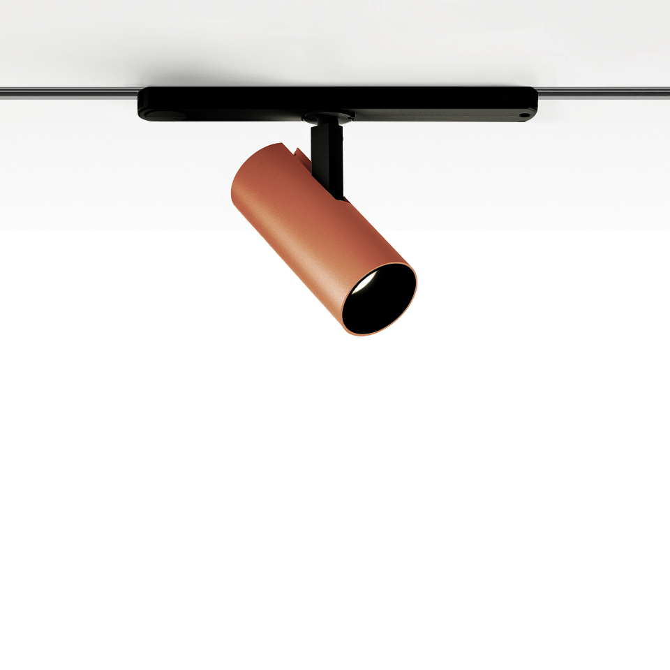 Artemide Vector Track 230V spotlight in terracotta, cylindrical body tilted on black track mount for directional lighting