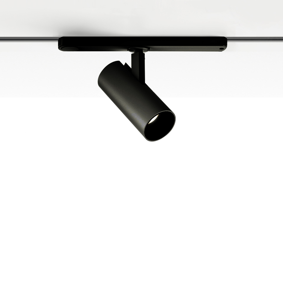 Artemide Vector Track 230V: black cylindrical adjustable spotlight mounted on a ceiling track rail, tilted at an angle