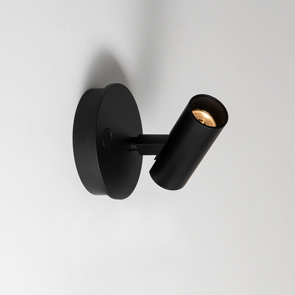 Artemide Vector Wall spotlight in matte black, adjustable cylindrical head on circular wall mount, directional LED light