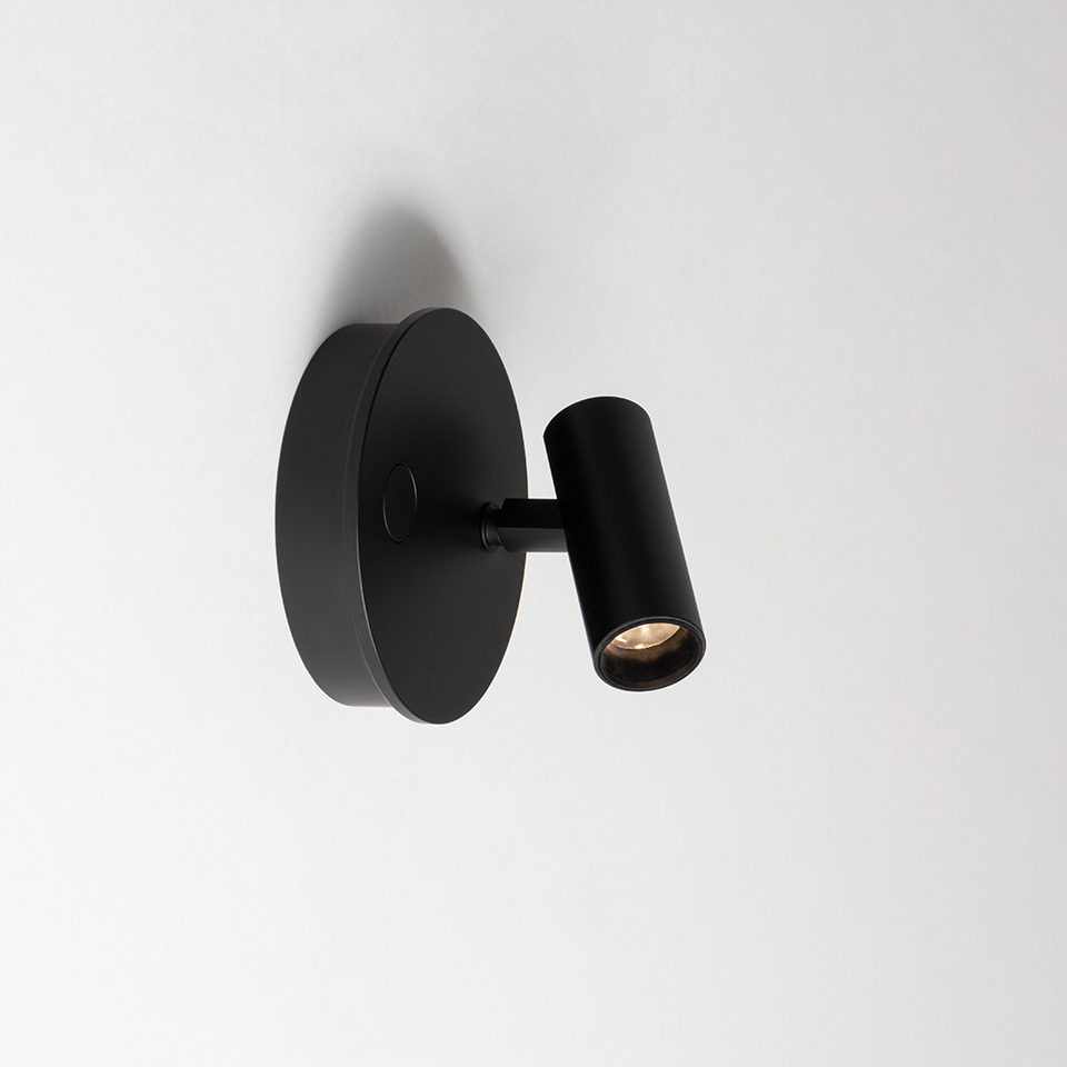 Artemide Vector Wall spotlight in matte black, circular wall base with adjustable cylindrical head for directional lighting