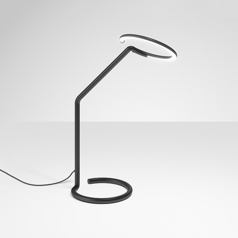 Artemide Vine Light table lamp: black sinuous stem with coiled base and circular LED ring head emitting white light
