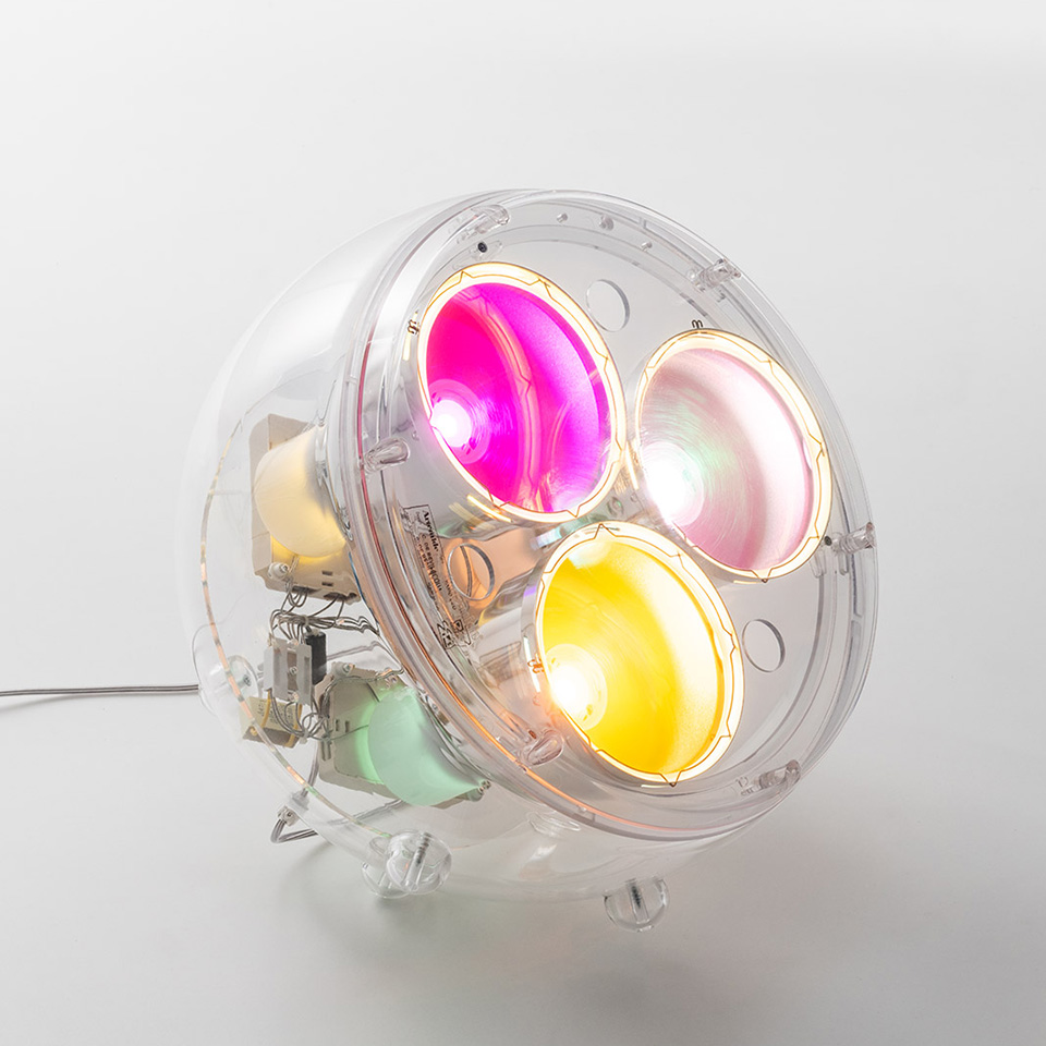 Artemide Yang LED lamp: transparent spherical body housing four colorful bowl-shaped reflectors in pink, white, yellow, and green tones