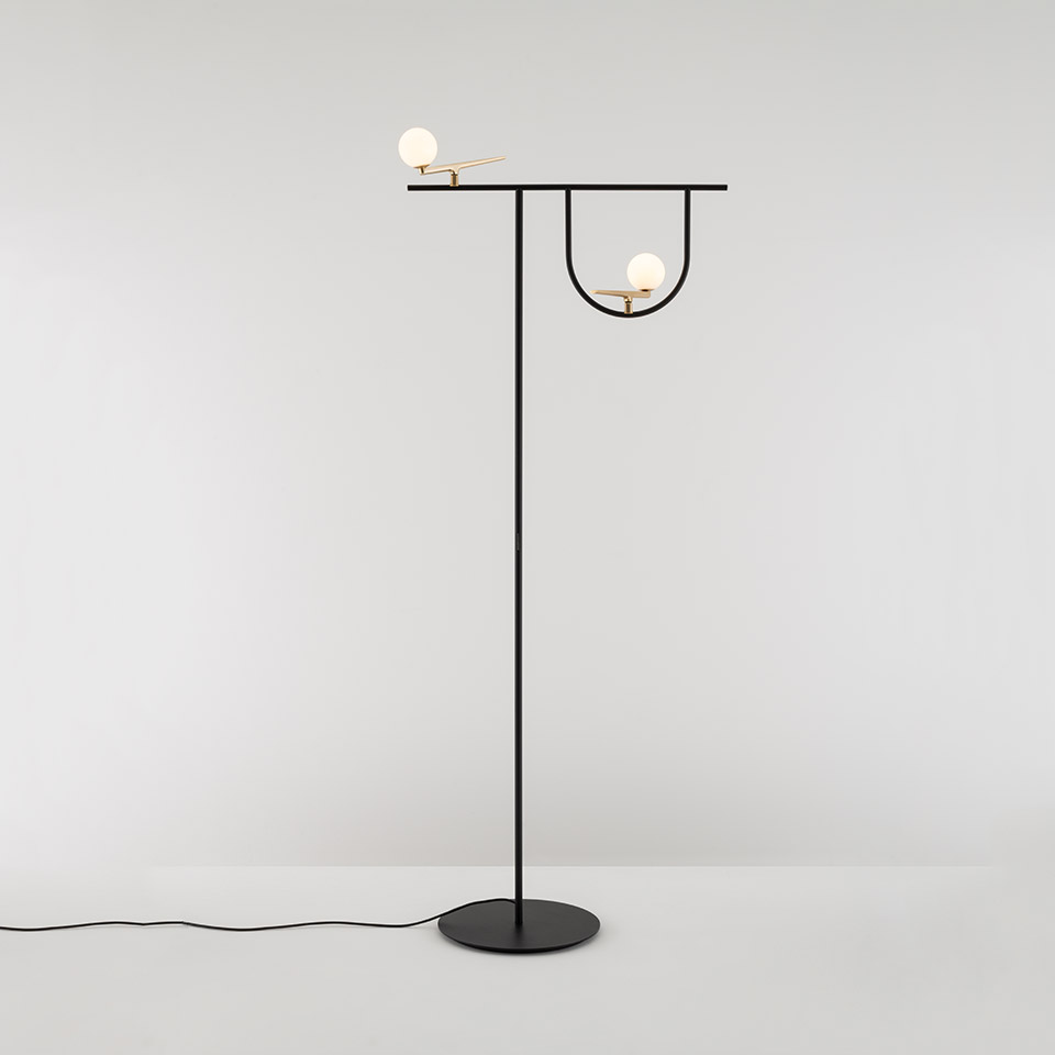 Artemide Yanzi floor lamp: black metal structure with two opal glass sphere lights, one on horizontal arm, one in U-shaped arc