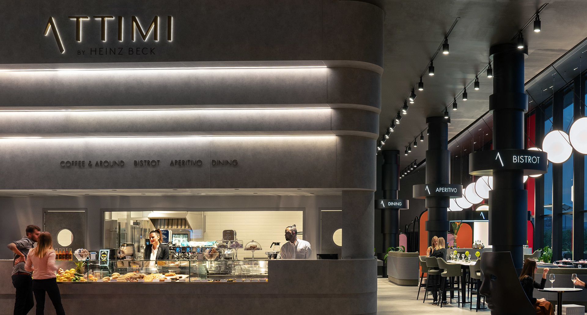 Attimi by Heinz Beck restaurant interior with pendant track lights and large spherical white globe lamps illuminating bistrot area