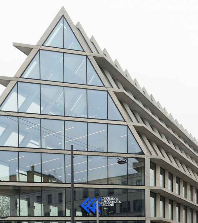 Fondazione Giangiacomo Feltrinelli building in Milan, triangular glass facade with Artemide linear LED ceiling lights visible inside