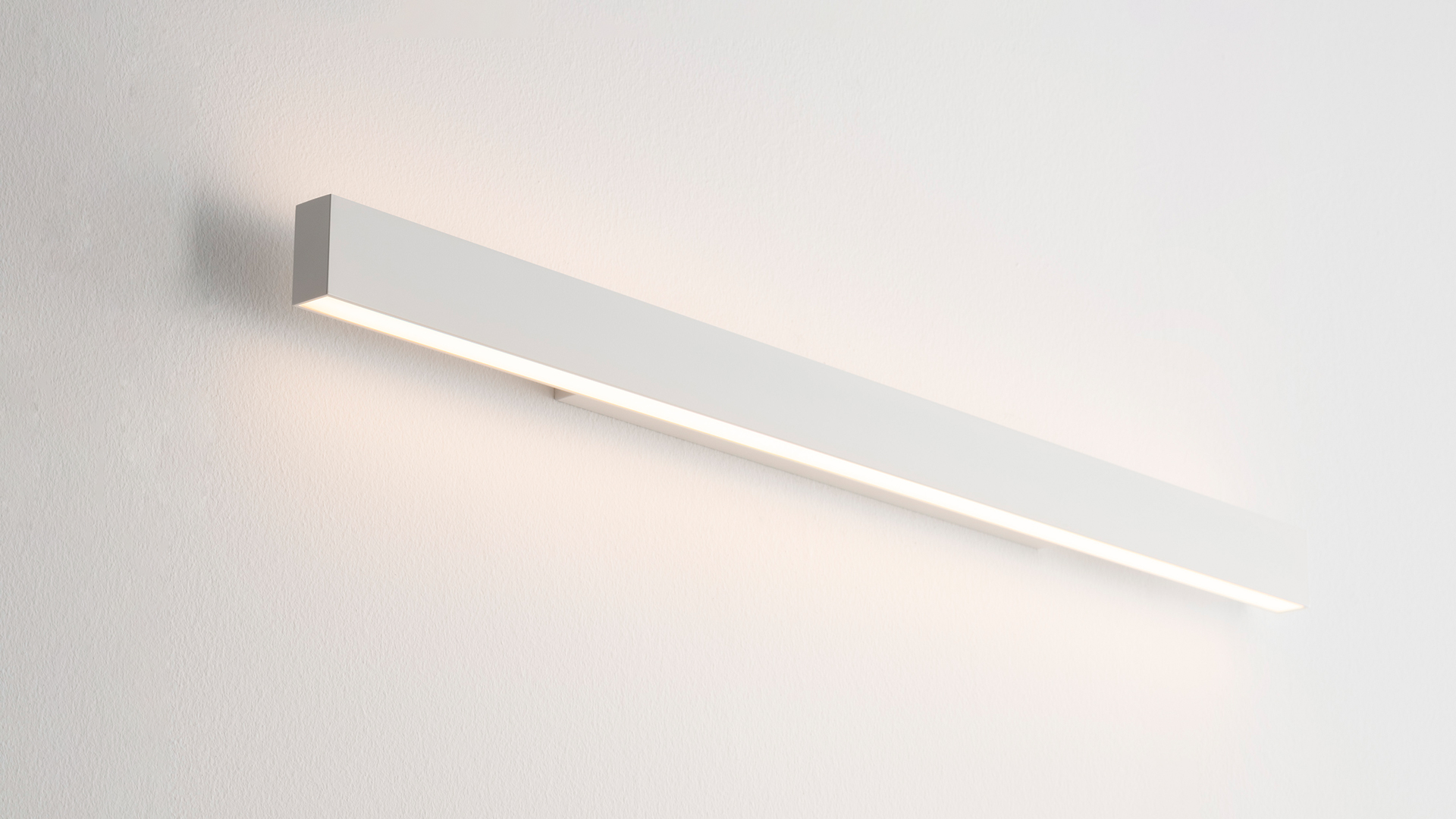 Artemide A.24 Parete wall lamp, rectangular black body with diffused LED light emitting from bottom and sides