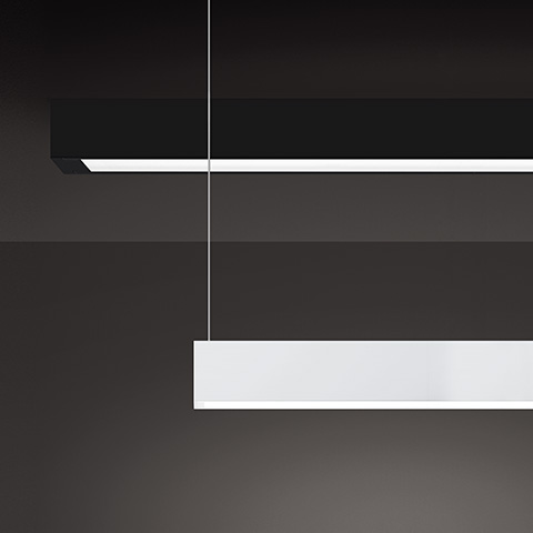Artemide A.39 pendant lamp with diffused emission, slim white rectangular body suspended by thin cable against dark background