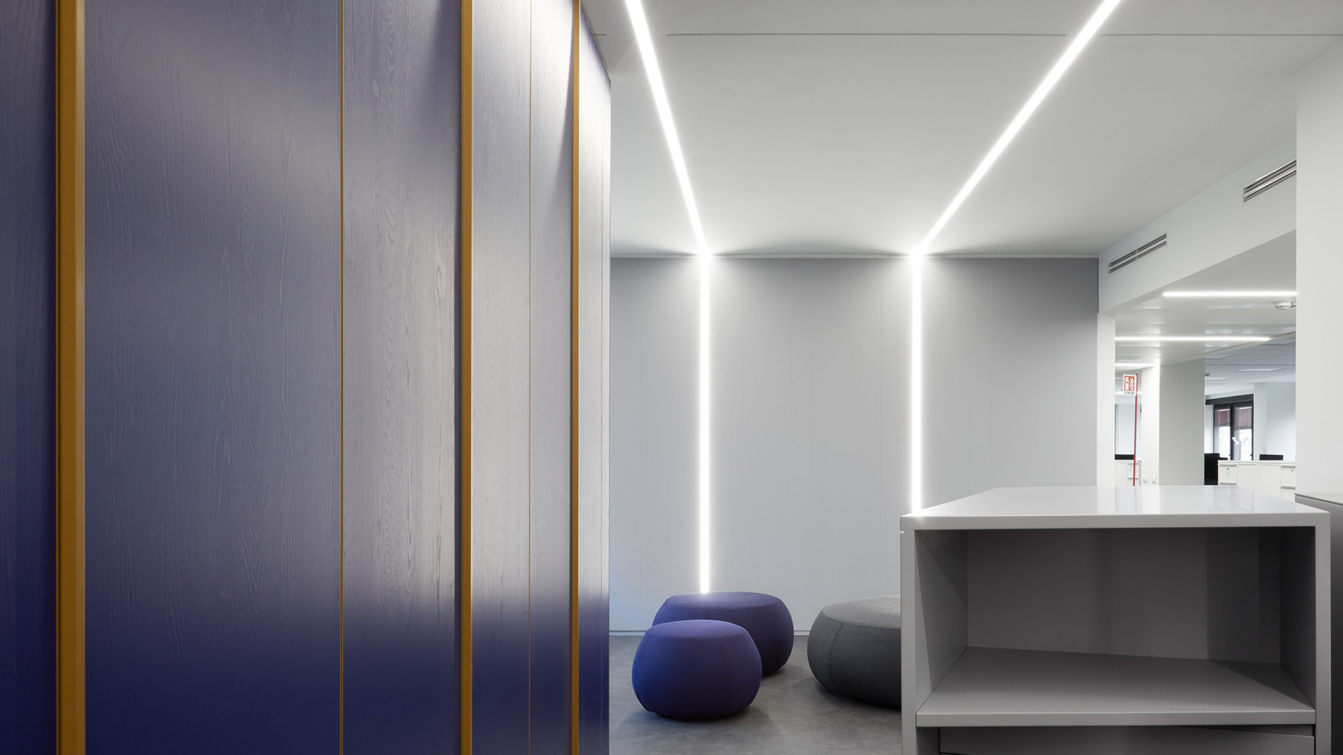 Artemide A.39 linear LED pendant and recessed lights with diffused emission, sleek white aluminum profiles on dark background