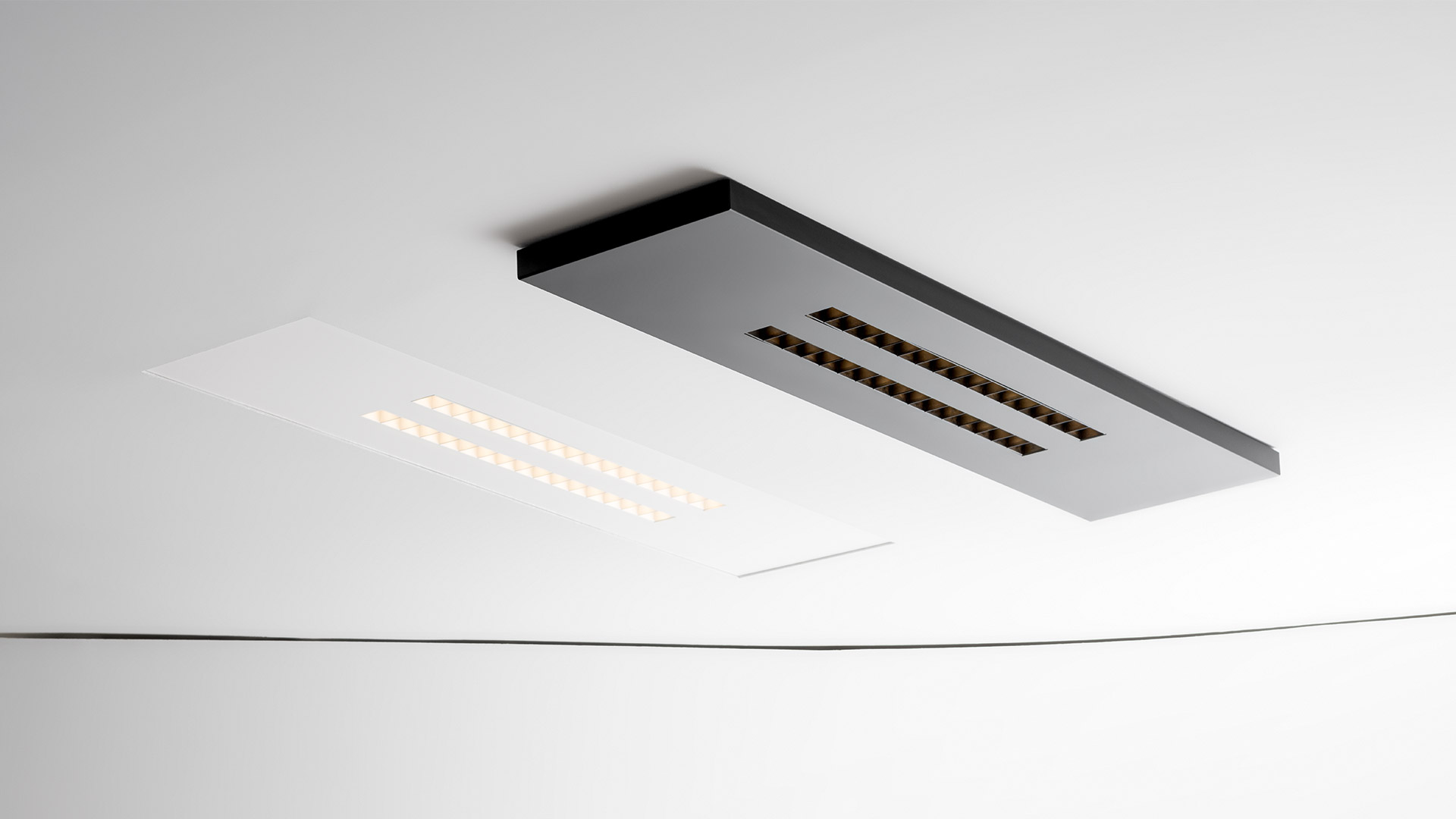 Artemide A.39 Refractive Square wall light: black square panel with three vertical rows of warm golden LED refractive lenses