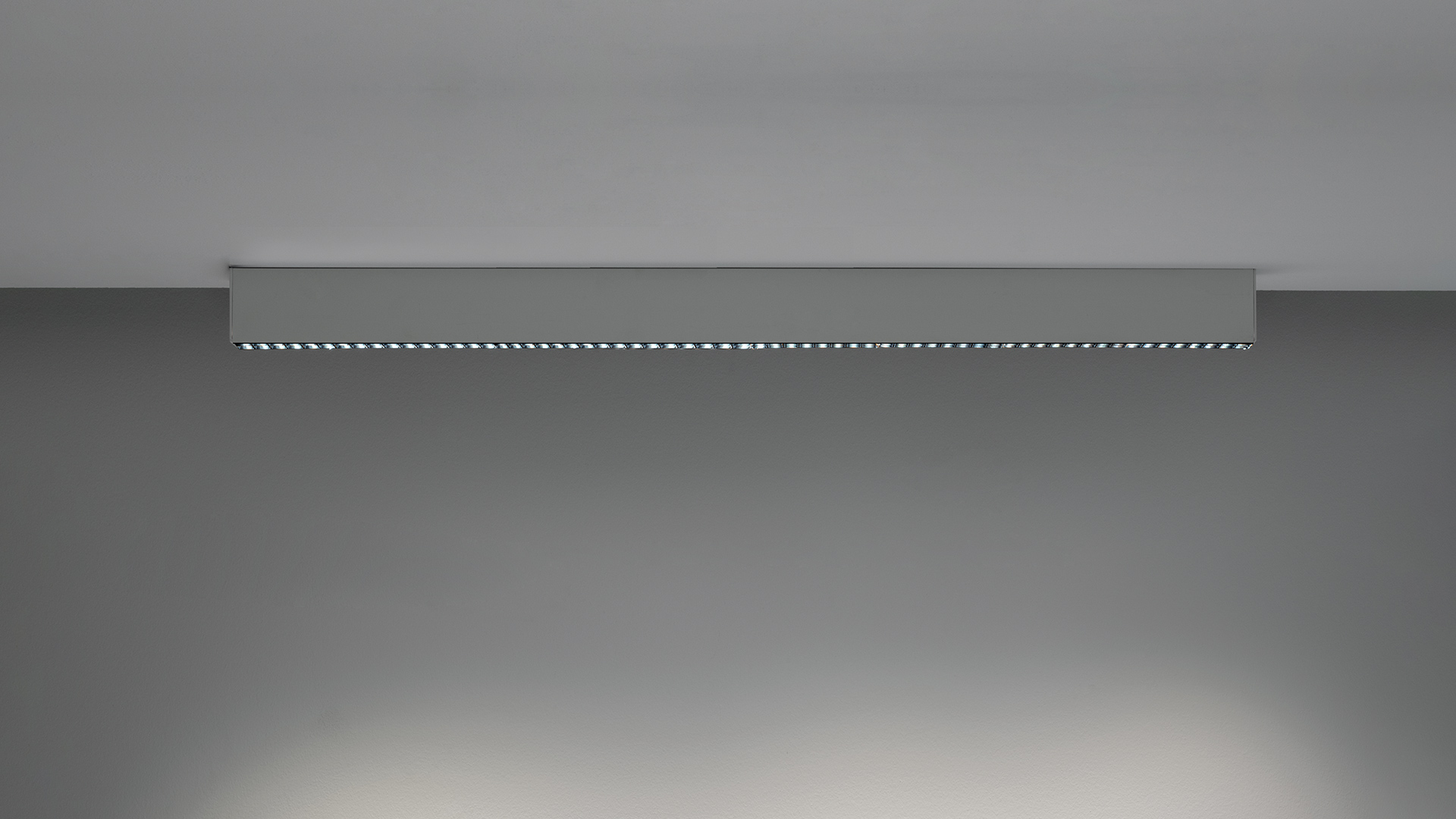 Artemide A.39 suspension lamps: left white diffuser with opal LEDs, right black body with gold microrefractive lens array