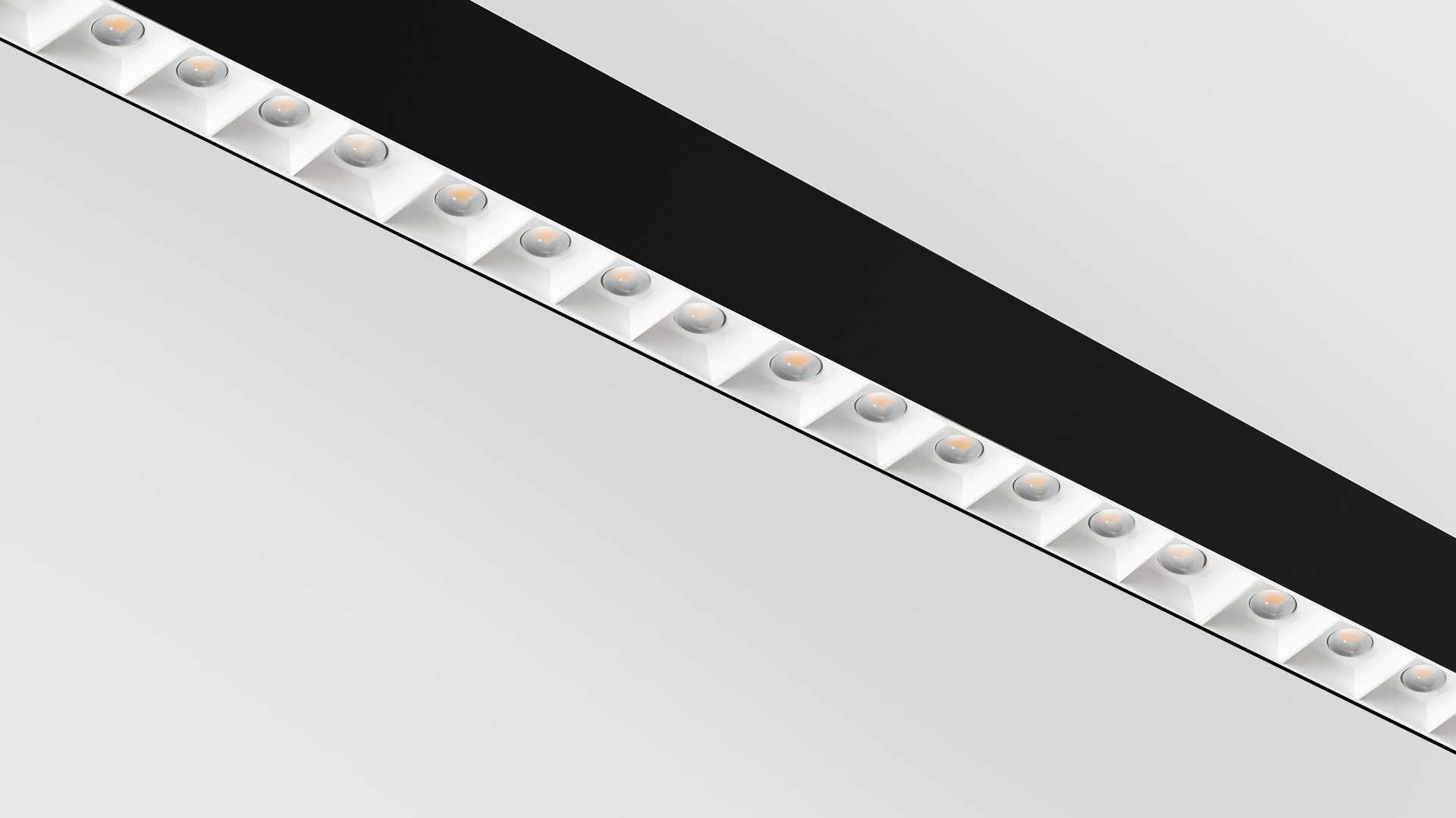 Artemide A.39 ceiling light: white linear fixture with five refractive LED lens modules emitting warm light