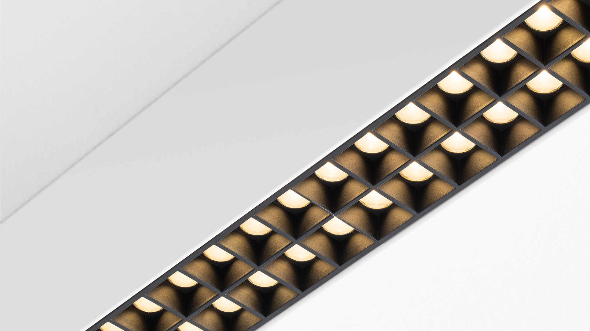 Artemide A.39 recessed ceiling light fixture with linear LED array and microrefractive optics, flush-mounted in white ceiling